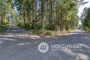 2218 Lybecker Road Northwest Gig Harbor, WA 98332 - Photo 2 of 10 a view of a wooden door and view of a tree