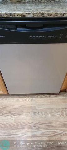 a living room with furniture wooden floor and a large window