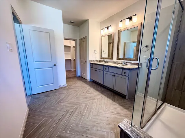 a large bathroom with mirror and a sink