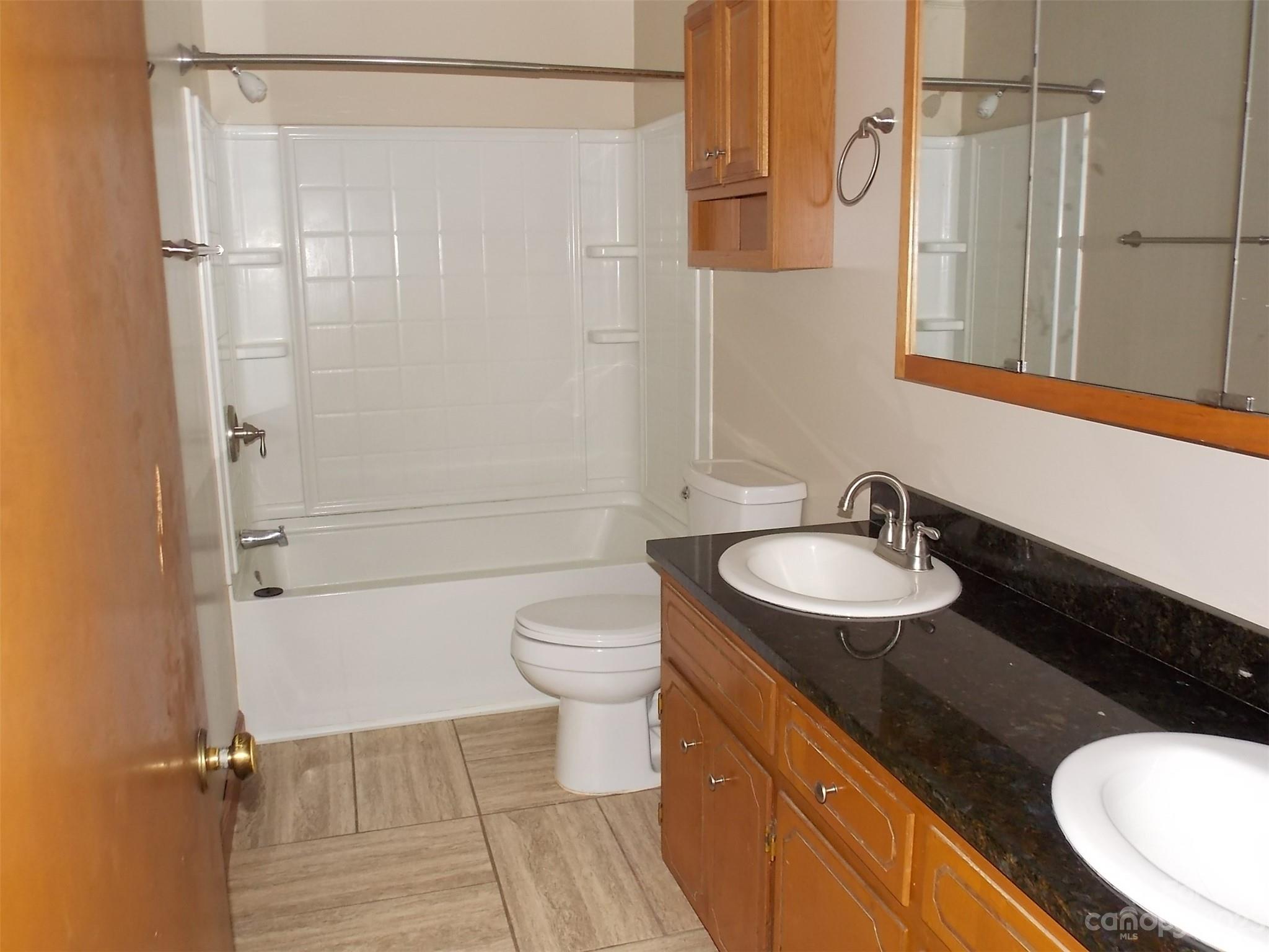 1800 Williams Road Fort Mill, SC 29715 - Photo 8 of 23 a bathroom with a sink toilet a mirror and shower