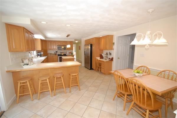 55 Ballardvale Road Andover, MA 01810 - Photo 8 of 26 a kitchen with stainless steel appliances kitchen island granite countertop a sink and cabinets