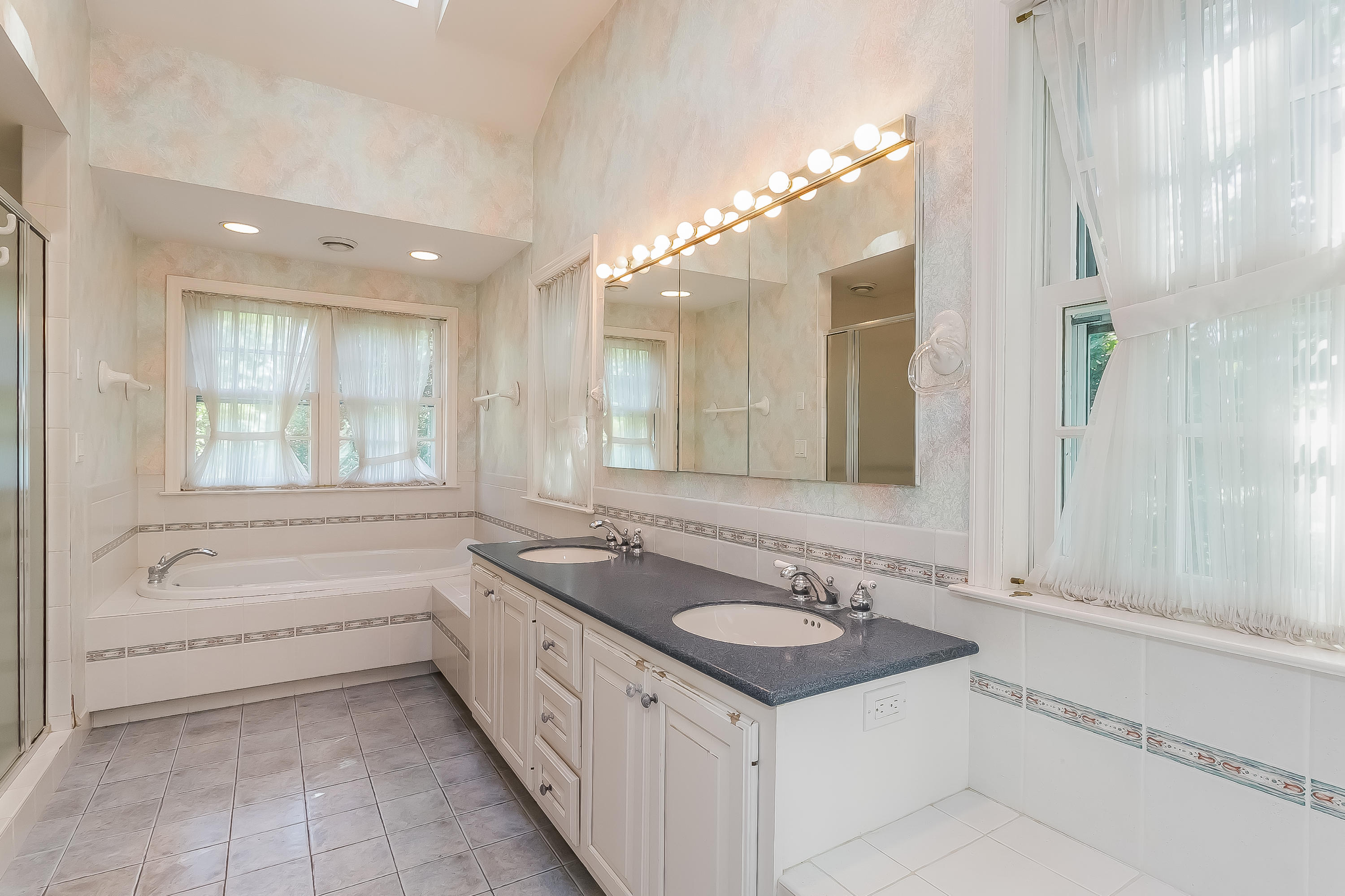 32 Hillsley Road Darien, CT 06820 - Photo 15 of 20 a spacious bathroom with a bathtub sink and mirror