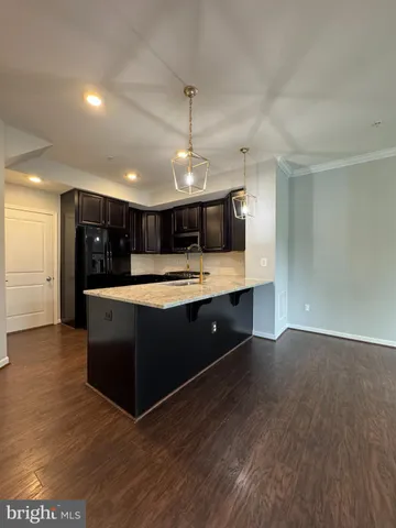 a kitchen with granite countertop wooden cabinets and stainless steel appliances