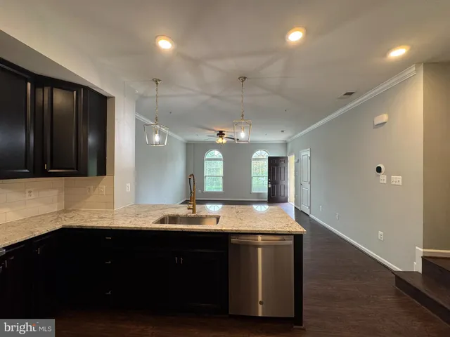 a large kitchen with stainless steel appliances a large counter top