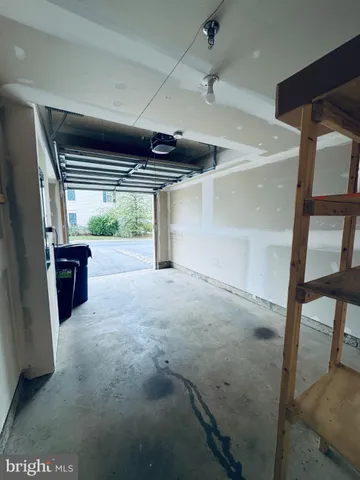 a large kitchen with wooden floor and cabinets