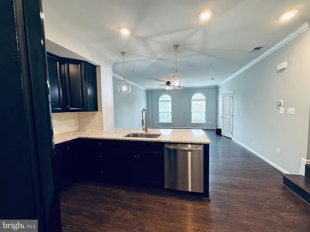 a kitchen with stainless steel appliances granite countertop a stove and a microwave