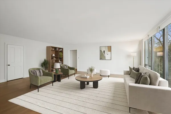 a living room with furniture and a potted plant