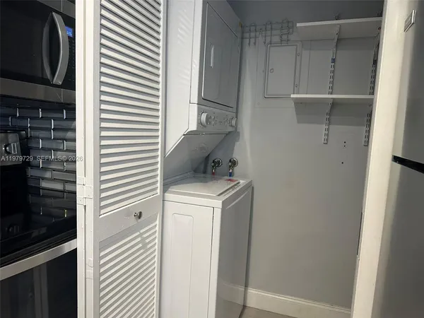 a bathroom with a toilet sink a mirror a shower and vanity