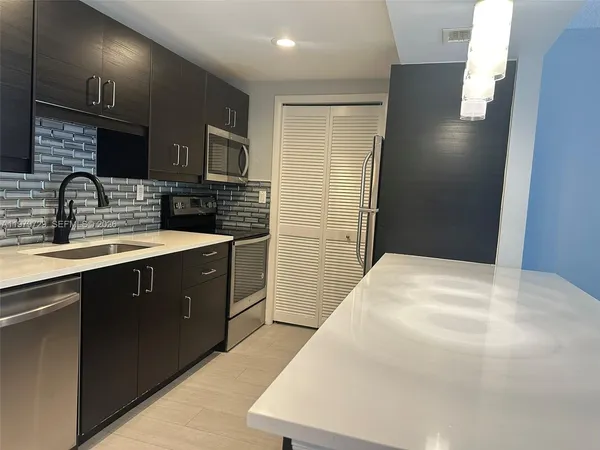 a view of a big room with wooden floor and a window