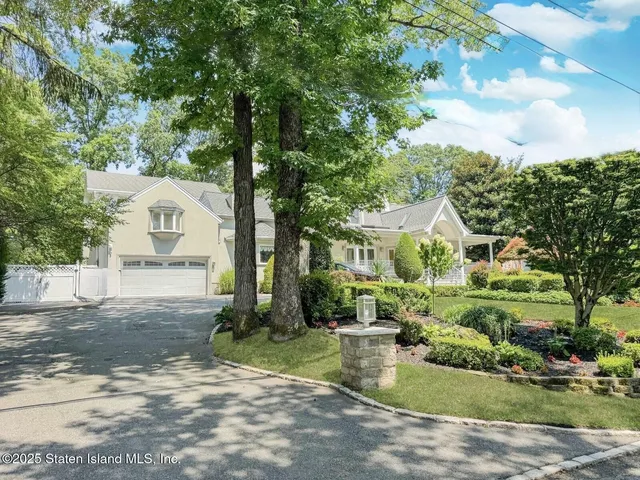 a kitchen with stainless steel appliances kitchen island granite countertop a table chairs and a refrigerator