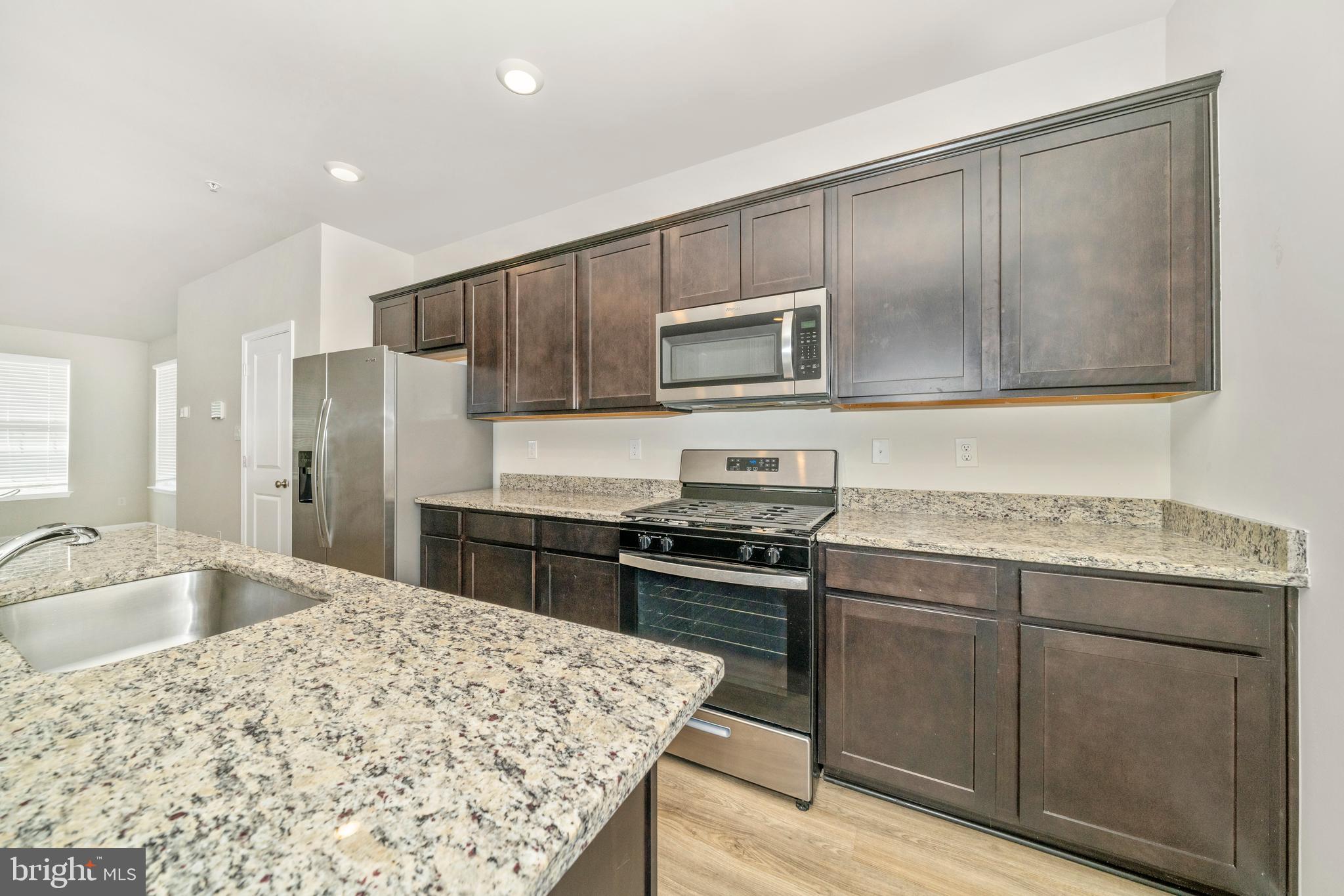 8634 Walter Martz Road Frederick, MD 21702 - Photo 13 of 52 a kitchen with stainless steel appliances granite countertop a sink stove and refrigerator