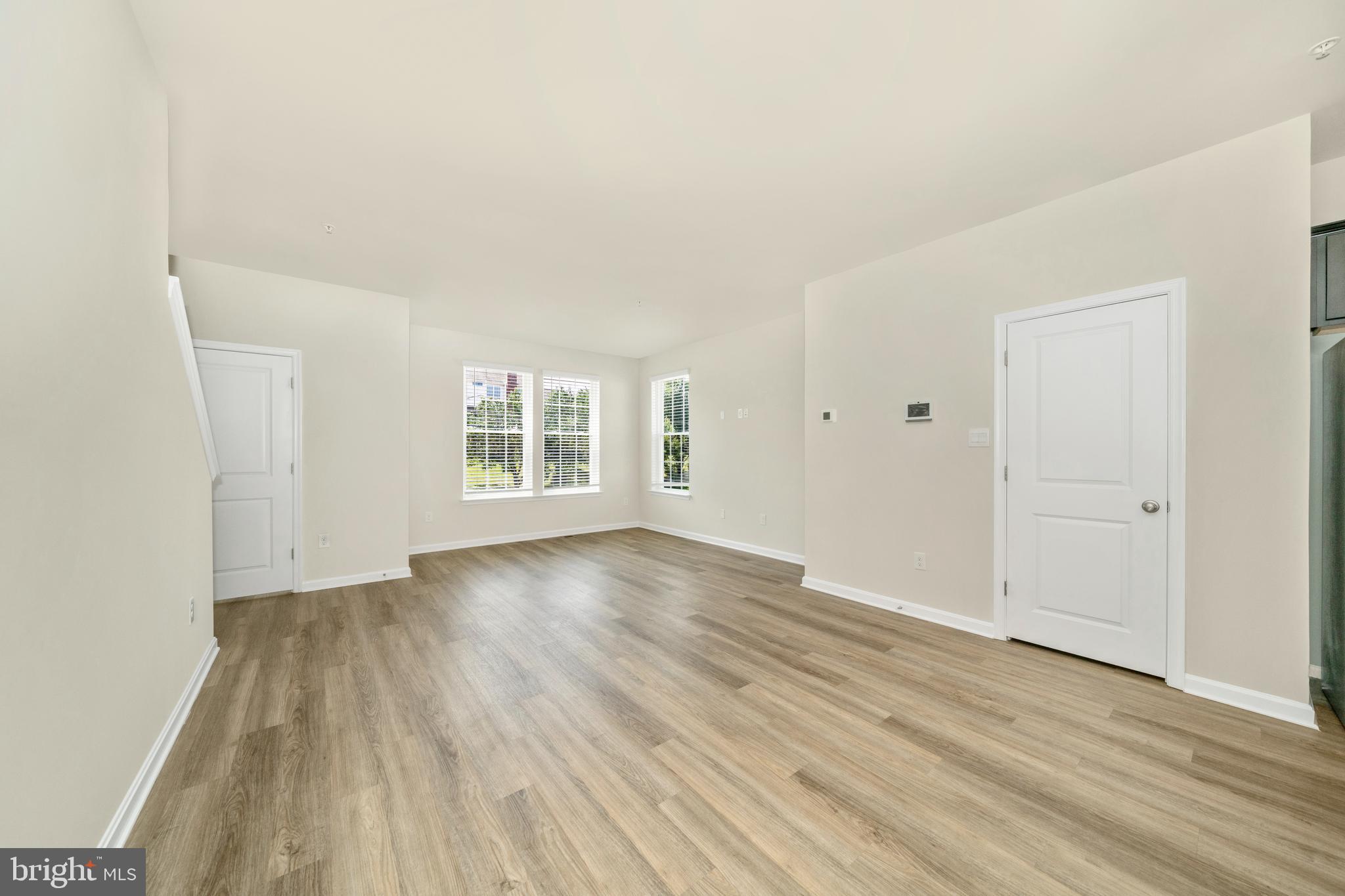 8634 Walter Martz Road Frederick, MD 21702 - Photo 24 of 52 a view of an empty room with wooden floor and a window