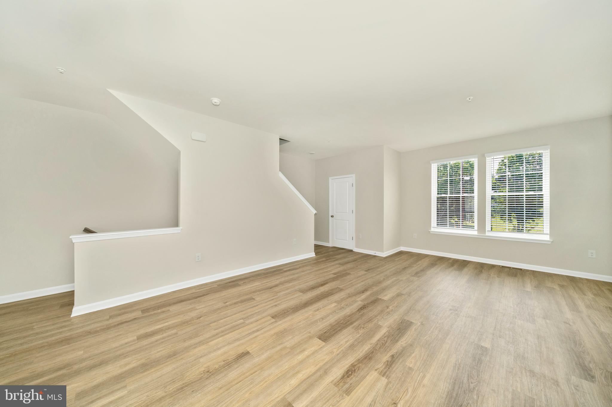 8634 Walter Martz Road Frederick, MD 21702 - Photo 25 of 52 a view of an empty room with wooden floor and a window