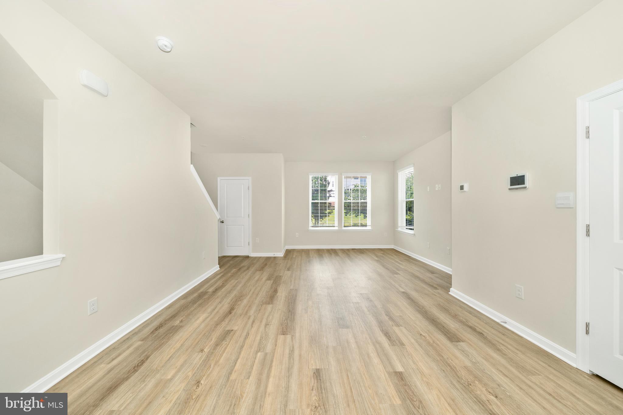 8634 Walter Martz Road Frederick, MD 21702 - Photo 26 of 52 an empty room with wooden floor and windows