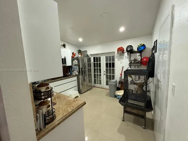 a hallway with a couch and chandelier