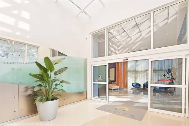 a vase of flowers sitting on a table with a potted plant