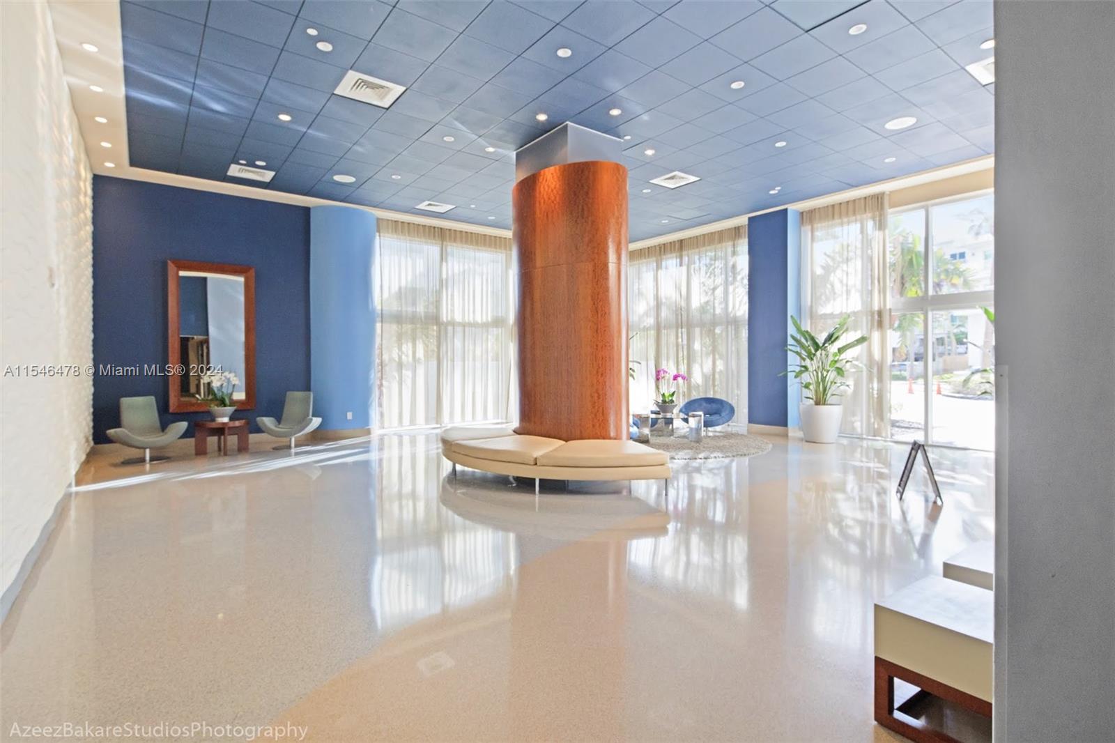 6365 Collins Avenue, Unit 1408 Miami Beach, FL 33141 - Photo 14 of 37 a view of a lobby with a floor to ceiling window and wooden floor