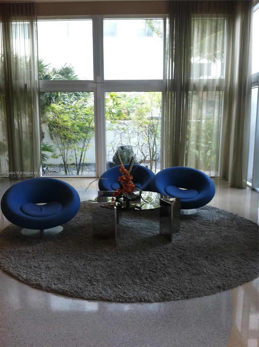 6365 Collins Avenue, Unit 1408 Miami Beach, FL 33141 - Photo 15 of 37 a living room with furniture and a floor to ceiling window