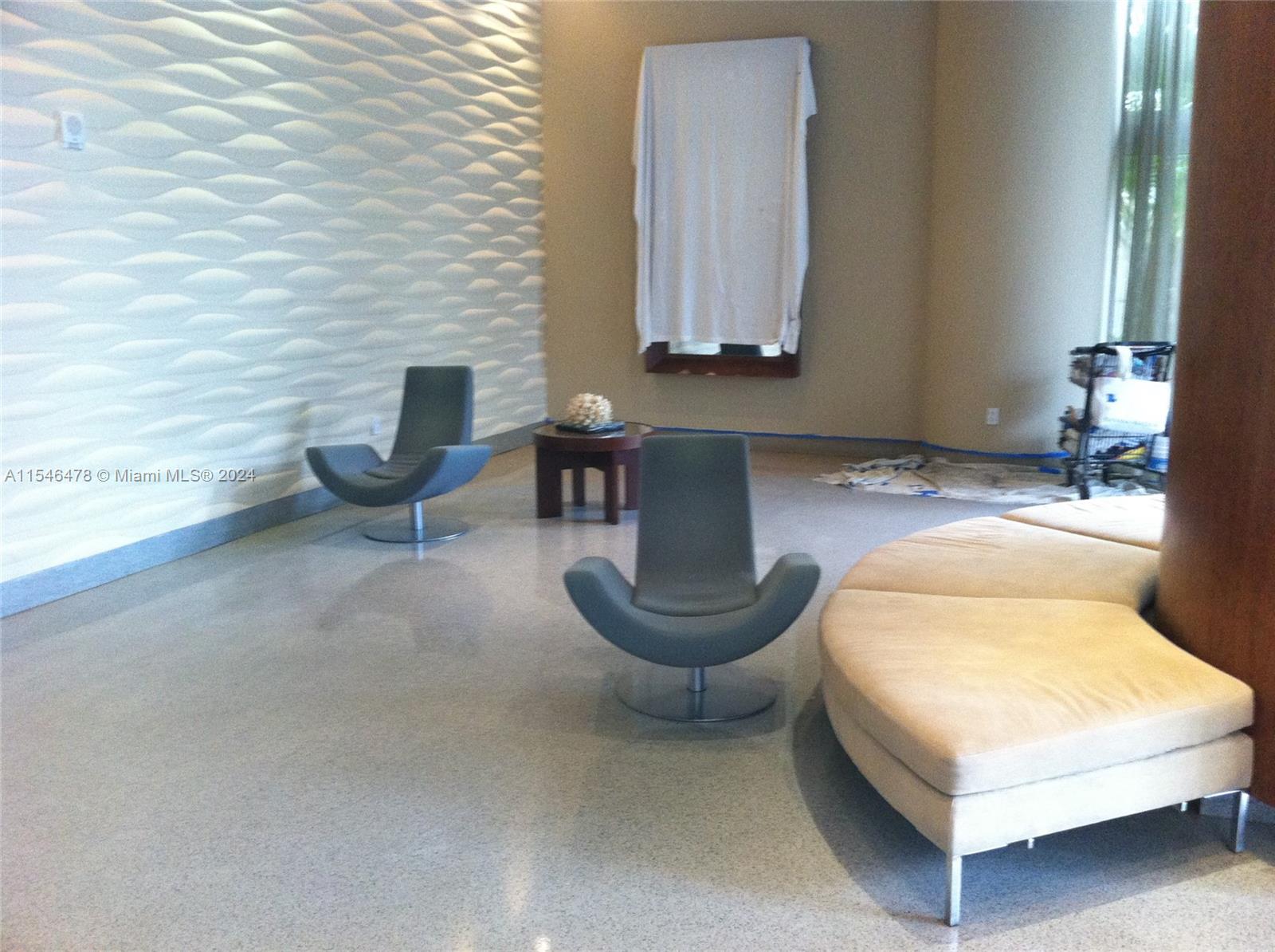 6365 Collins Avenue, Unit 1408 Miami Beach, FL 33141 - Photo 16 of 37 a living room with furniture and a potted plant