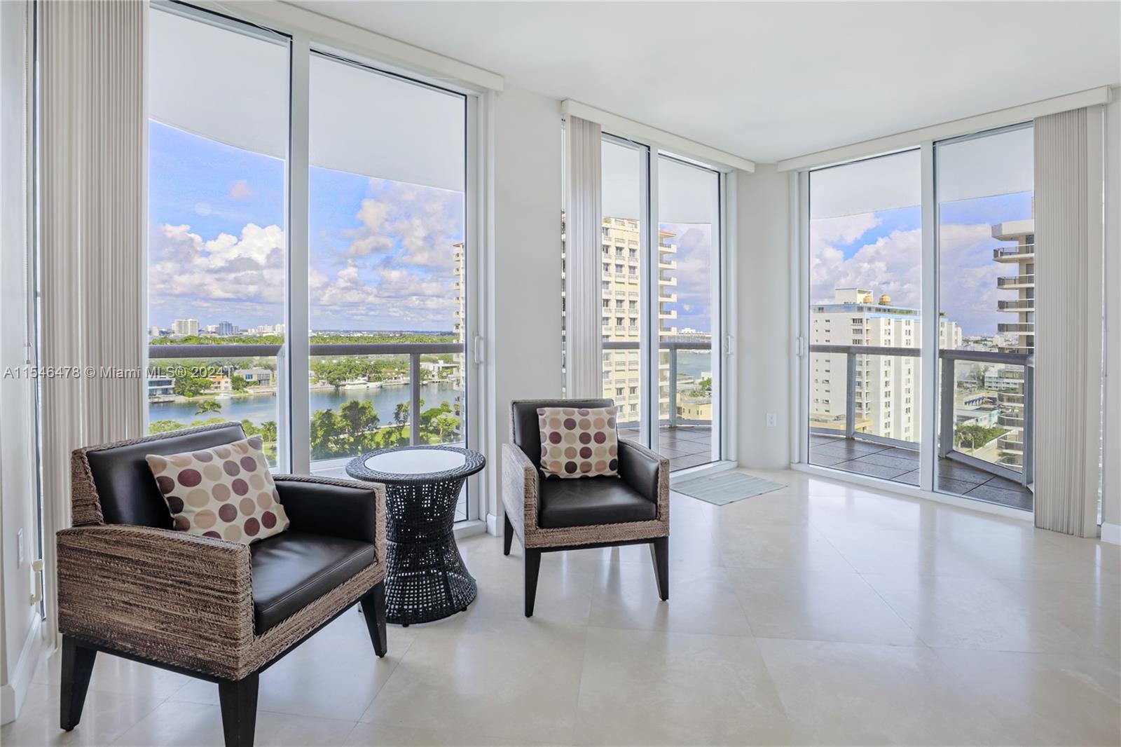 6365 Collins Avenue, Unit 1408 Miami Beach, FL 33141 - Photo 18 of 37 a living room with furniture and large windows