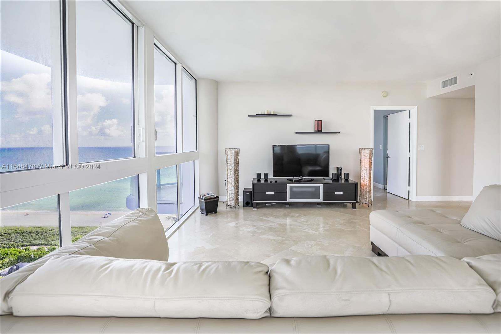 6365 Collins Avenue, Unit 1408 Miami Beach, FL 33141 - Photo 19 of 37 a living room with furniture and a flat screen tv