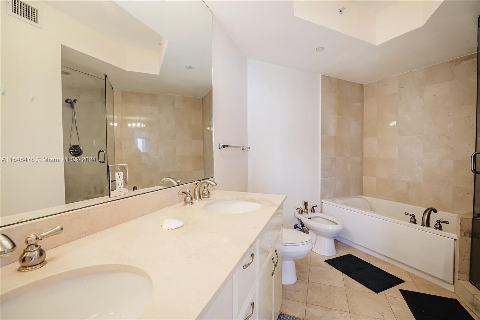 6365 Collins Avenue, Unit 1408 Miami Beach, FL 33141 - Photo 22 of 37 a bathroom with a tub a sink and mirror