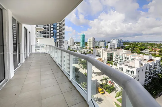 a view of a balcony with floor to ceiling windows