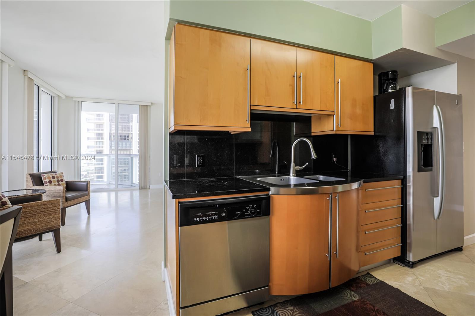 6365 Collins Avenue, Unit 1408 Miami Beach, FL 33141 - Photo 37 of 37 a kitchen with stainless steel appliances granite countertop a stove a sink and a microwave