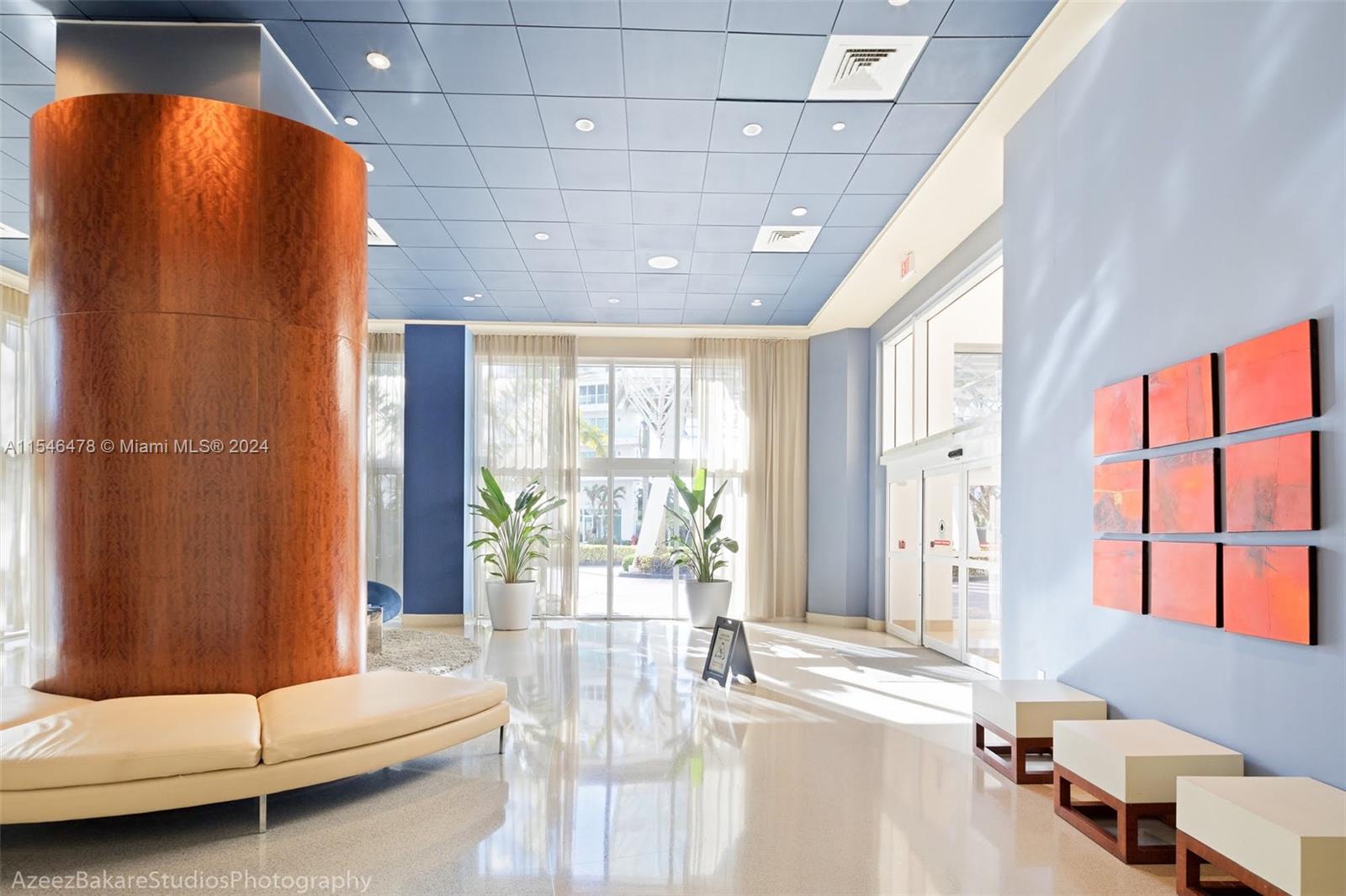 6365 Collins Avenue, Unit 1408 Miami Beach, FL 33141 - Photo 10 of 37 a living room with furniture and a large window