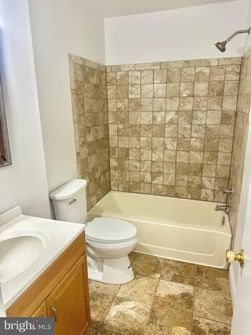 a bathroom with a sink a toilet and bathtub