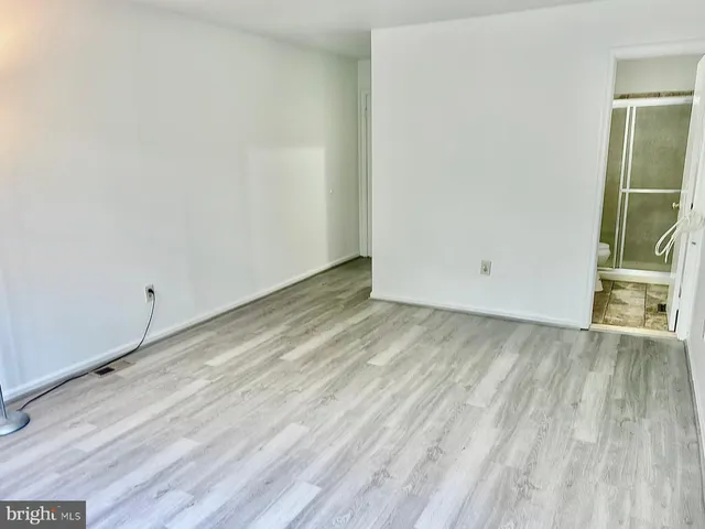 a view of a room with wooden floor