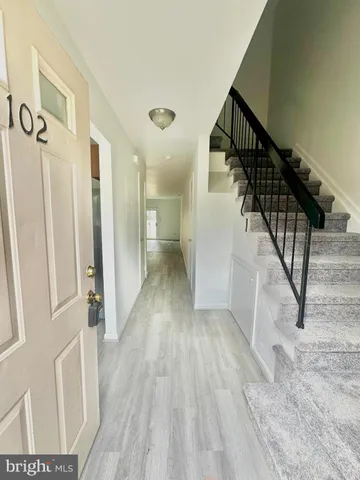 a view of entryway with wooden floor and stairs