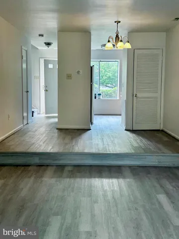 a view of hallway with wooden floor