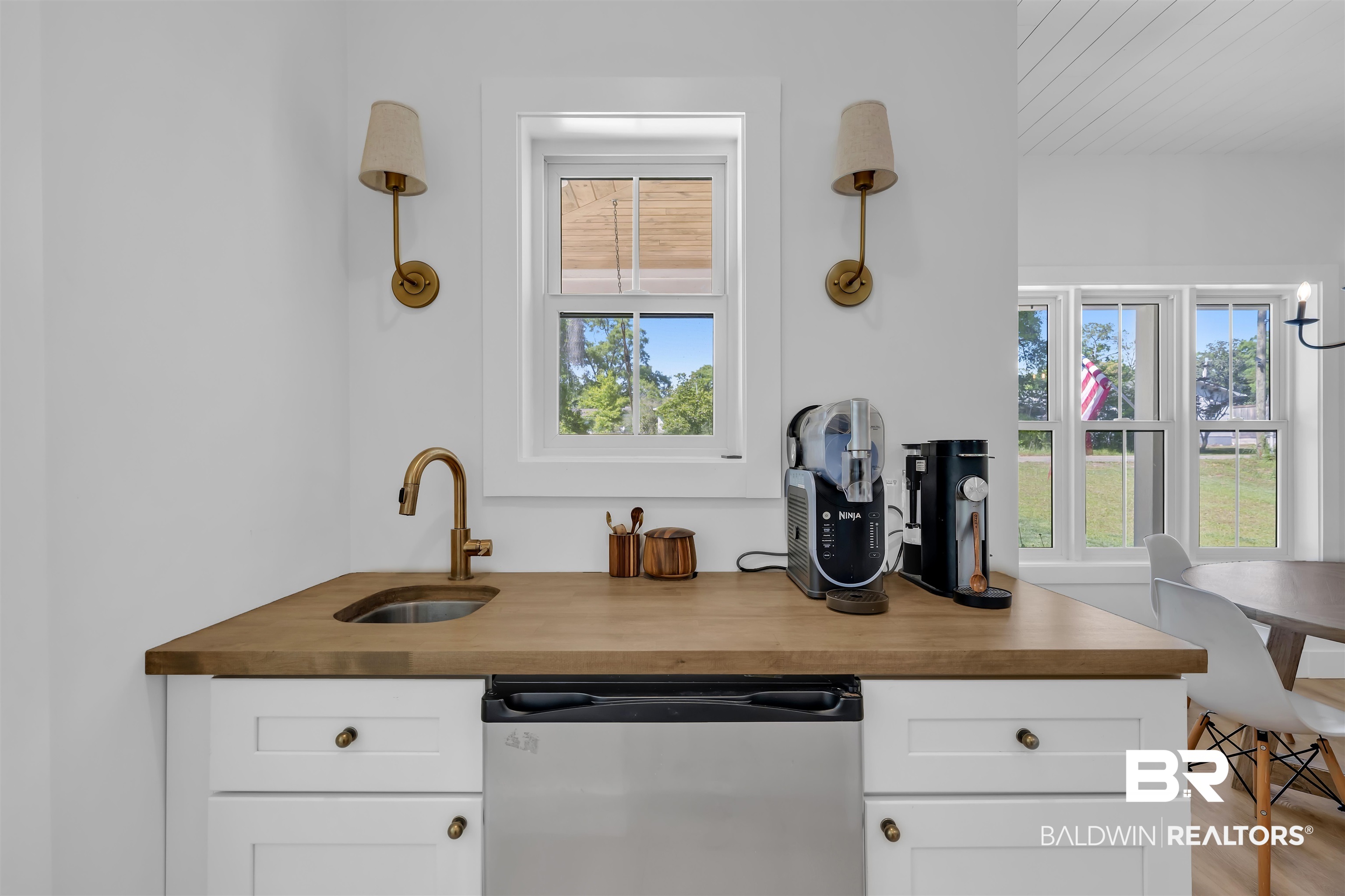 19058 James Road Gulf Shores, AL 36542 - Photo 16 of 49 Kitchen with butcher block counters, stainless steel dishwasher, and white cabinetry