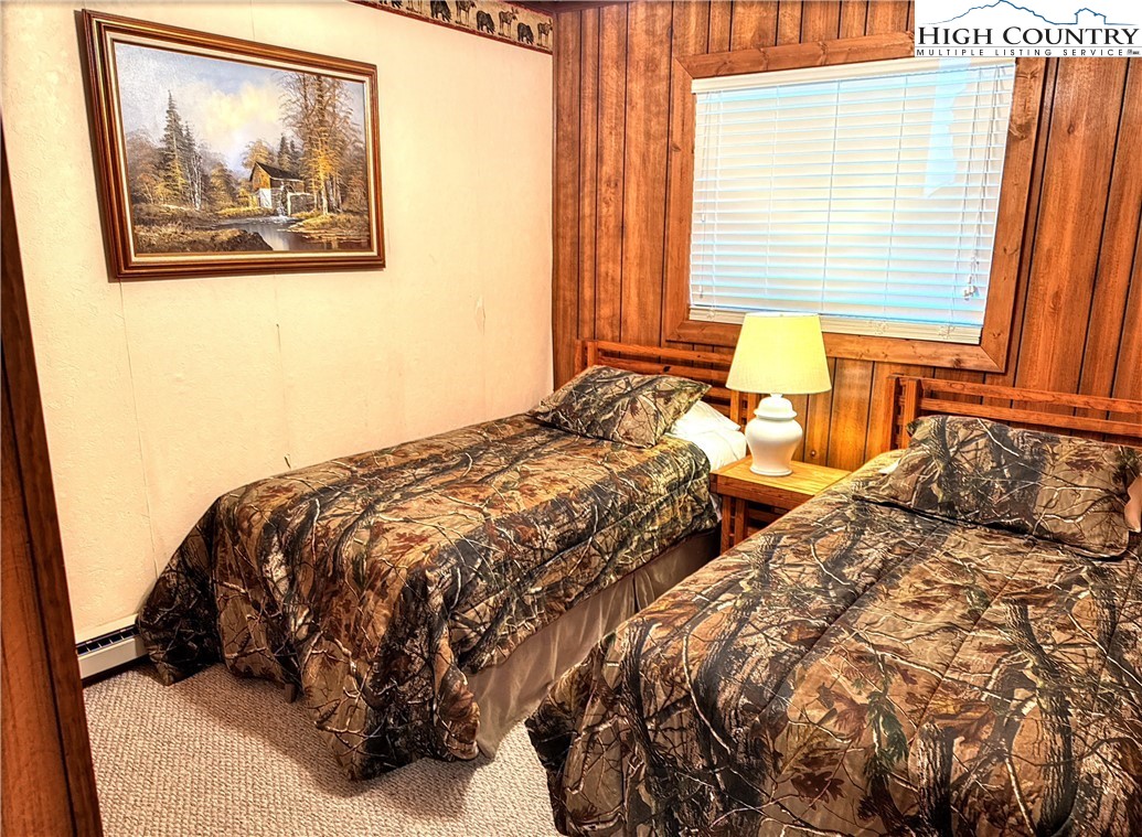301 Pinnacle Inn Road, Unit 2105 Beech Mountain, NC 28604 - Photo 12 of 23 a bedroom with a bed and a painting on the wall