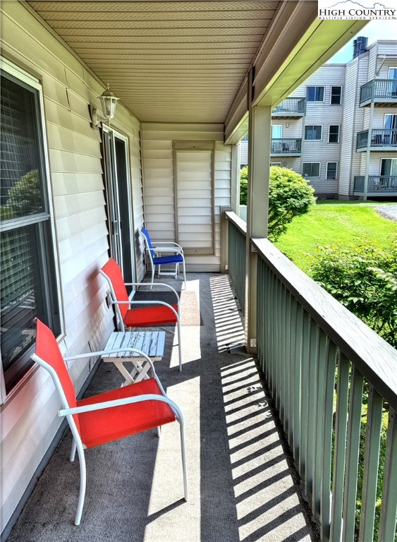 301 Pinnacle Inn Road, Unit 2105 Beech Mountain, NC 28604 - Photo 16 of 23 a balcony with chairs and wooden deck