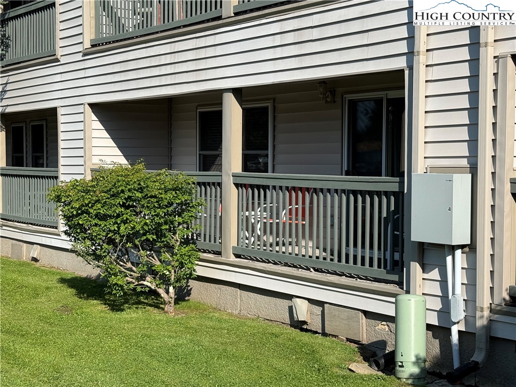 301 Pinnacle Inn Road, Unit 2105 Beech Mountain, NC 28604 - Photo 17 of 23 a view of a house with a small yard and wooden fence