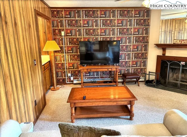 a living room with furniture pool and flat screen tv