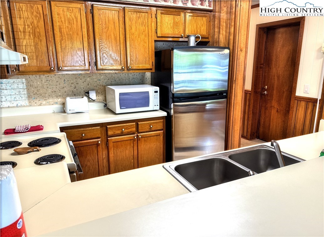 301 Pinnacle Inn Road, Unit 2105 Beech Mountain, NC 28604 - Photo 7 of 23 a kitchen with granite countertop a sink a counter top space and cabinets