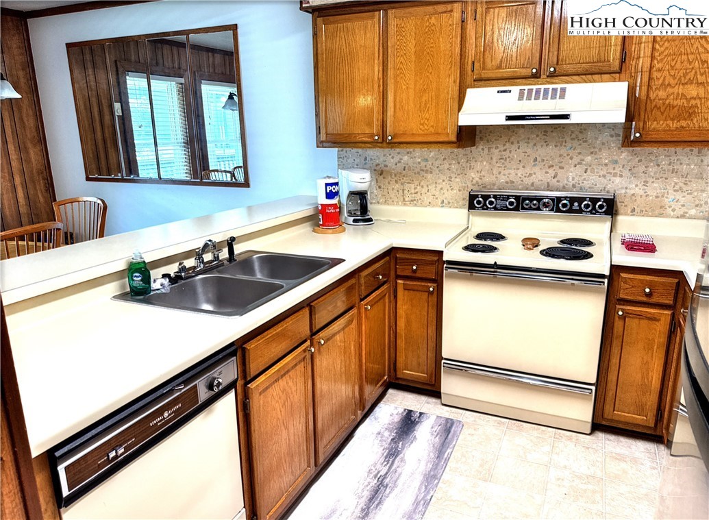 301 Pinnacle Inn Road, Unit 2105 Beech Mountain, NC 28604 - Photo 8 of 23 a kitchen with a sink and a stove top oven