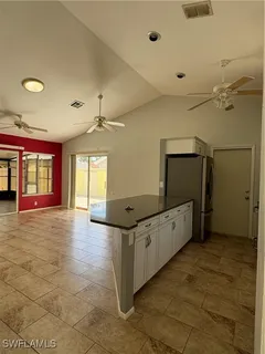 a kitchen with granite countertop a stove and cabinets