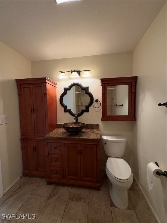 5560 Longleaf Drive North Fort Myers, FL 33917 - Photo 16 of 40 a bathroom with a toilet a sink and mirror