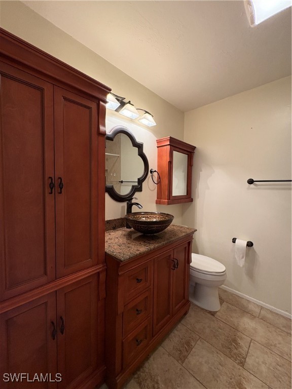 5560 Longleaf Drive North Fort Myers, FL 33917 - Photo 17 of 40 a bathroom with a granite countertop toilet sink and mirror