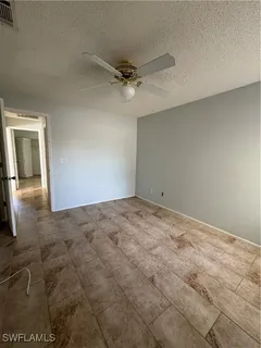 an empty room with a empty space and windows