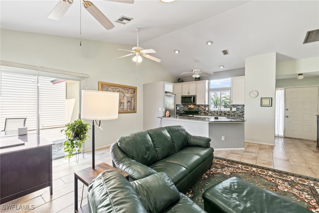 5560 Longleaf Drive North Fort Myers, FL 33917 - Photo 29 of 40 a living room with stainless steel appliances kitchen island granite countertop furniture and a view of kitchen