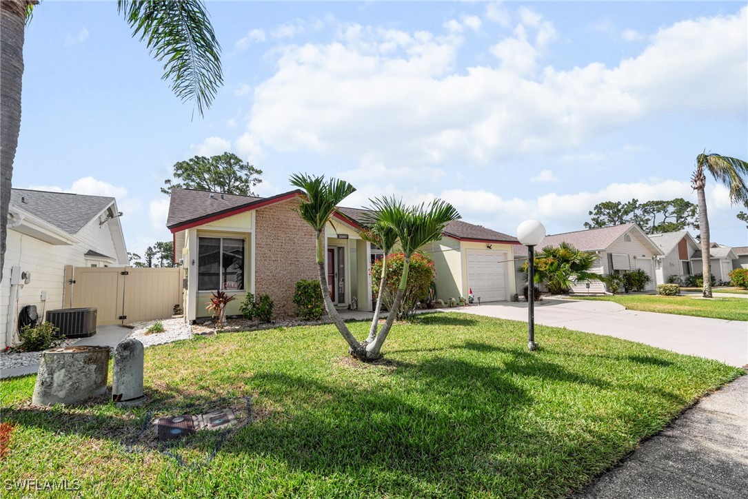 5560 Longleaf Drive North Fort Myers, FL 33917 - Photo 3 of 40 a view of a house with a yard and potted plants