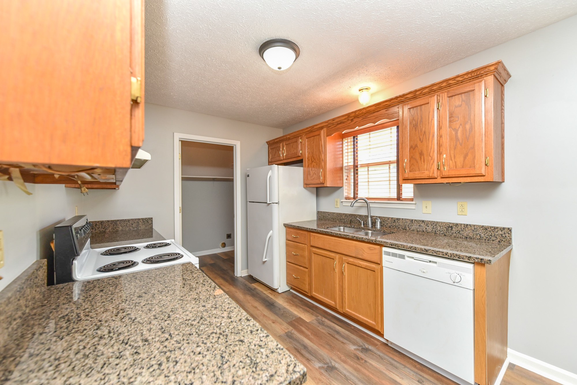 105 Phillip Drive Springfield, TN 37172 - Photo 14 of 24 a kitchen with stainless steel appliances granite countertop a stove sink and cabinets