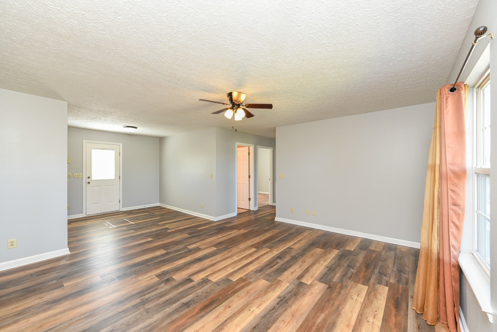 105 Phillip Drive Springfield, TN 37172 - Photo 7 of 24 a view of an empty room with wooden floor and a window