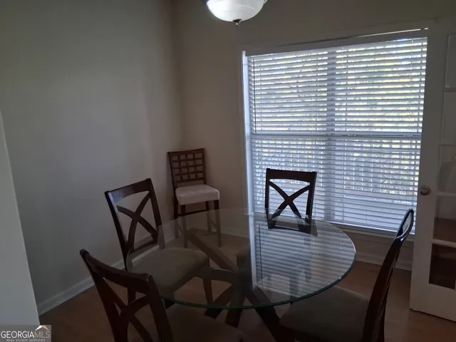 a dining room with furniture and wooden floor