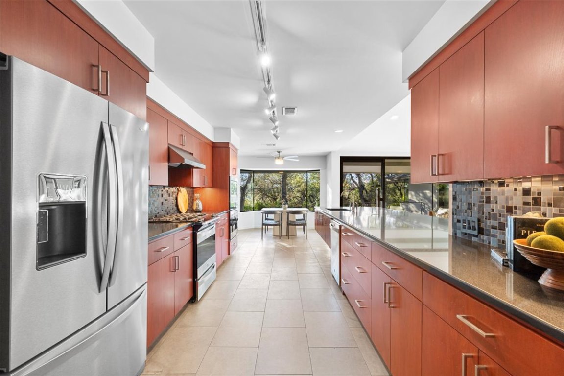 3923 Glengarry Drive Austin, TX 78731 - Photo 12 of 33 a large kitchen with lots of counter space cabinets and stainless steel appliances